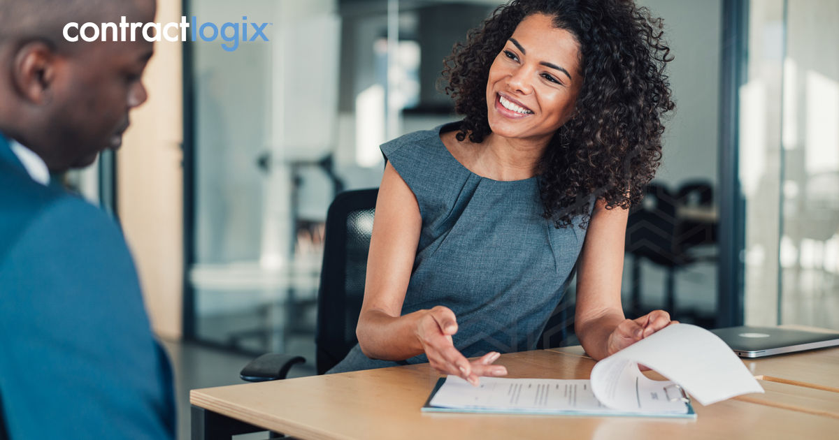 Business people signing a contract, demonstrating how to mitigate legal risk through effective contract management.