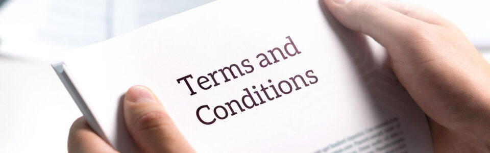 Individual reading terms and conditions as part of insurance brokerage contract management.