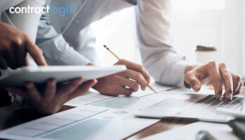A focused investor analyzing contracts, highlighting the importance of contract analysis in business success.