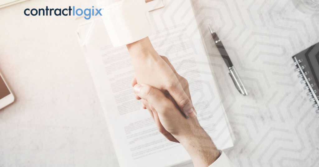 Two people shaking hands over a collaboration agreement.