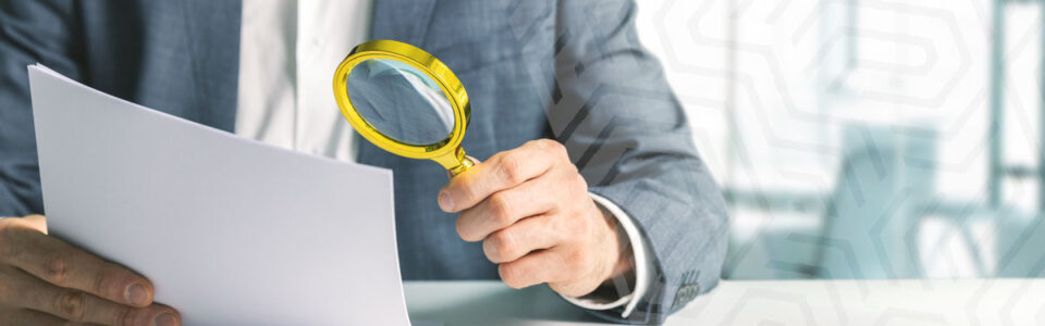 Businessperson conducting contract review with a magnifying glass.