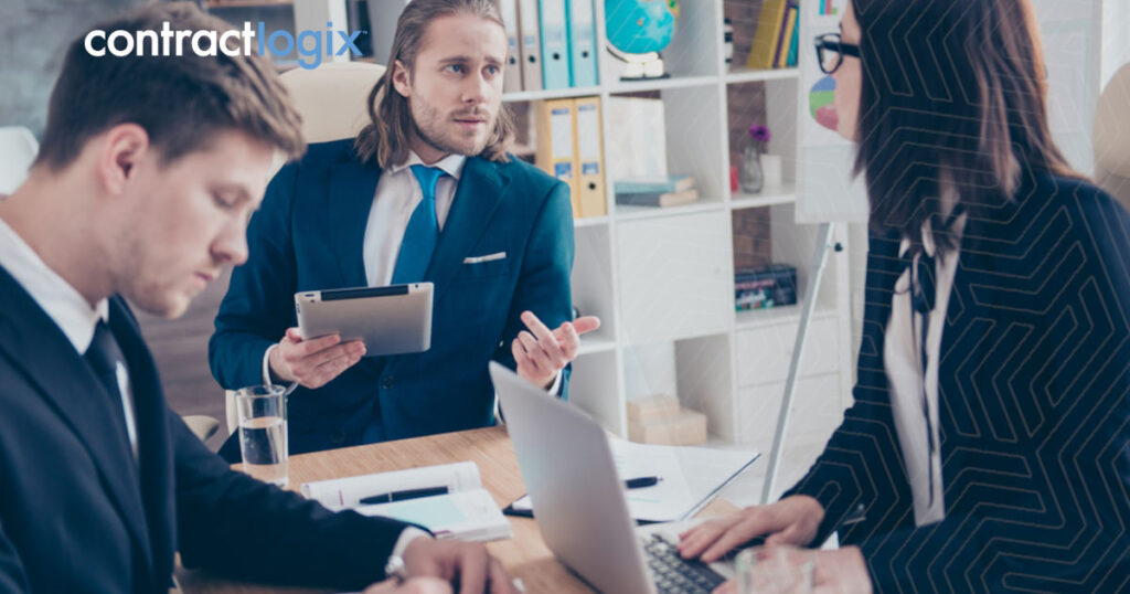 Three office workers using contract administration software.