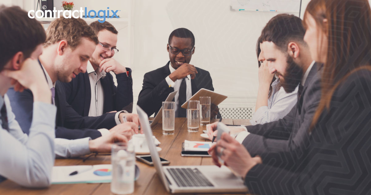 A diverse team of professionals negotiating SaaS contracts, gathered in a modern office setting, focused on strategic discussions.