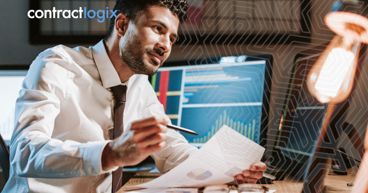 businessman holds paper and looks at computer screen while utilizing contract management for regulated industries
