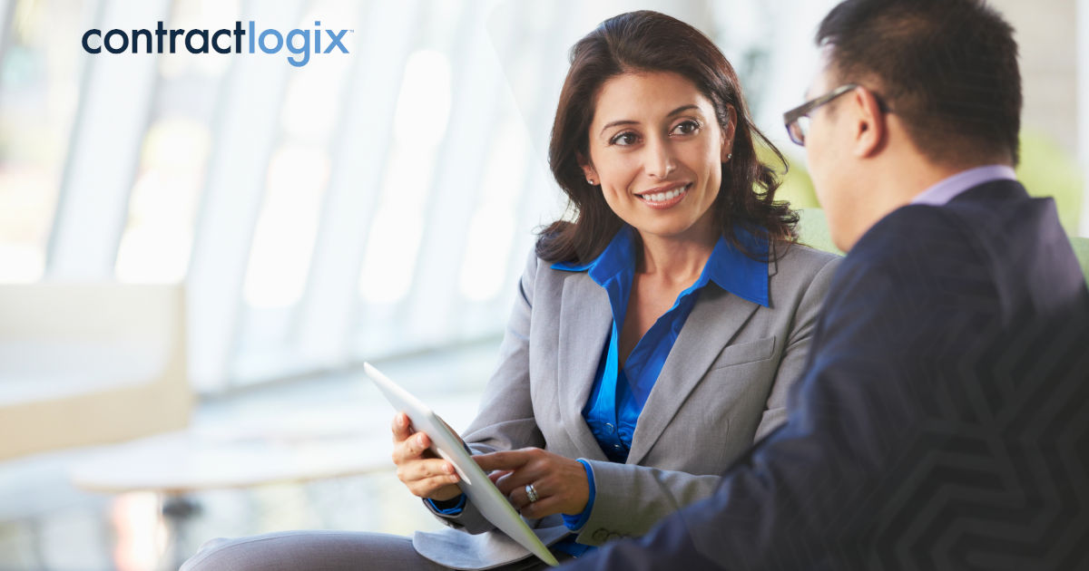 business colleagues with digital tablet discuss navigating compliance with enterprise contract management systems