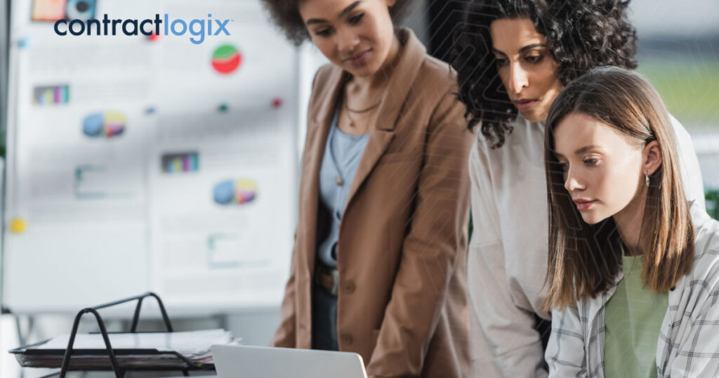 three businesswomen in an office using laptop computer to integrate a contract tracking software solution