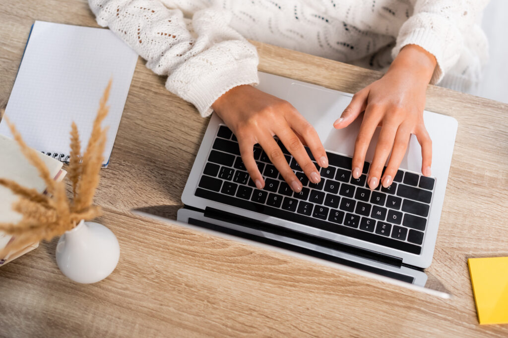 view of businesswoman typing on laptop at home to learn what is CLM software