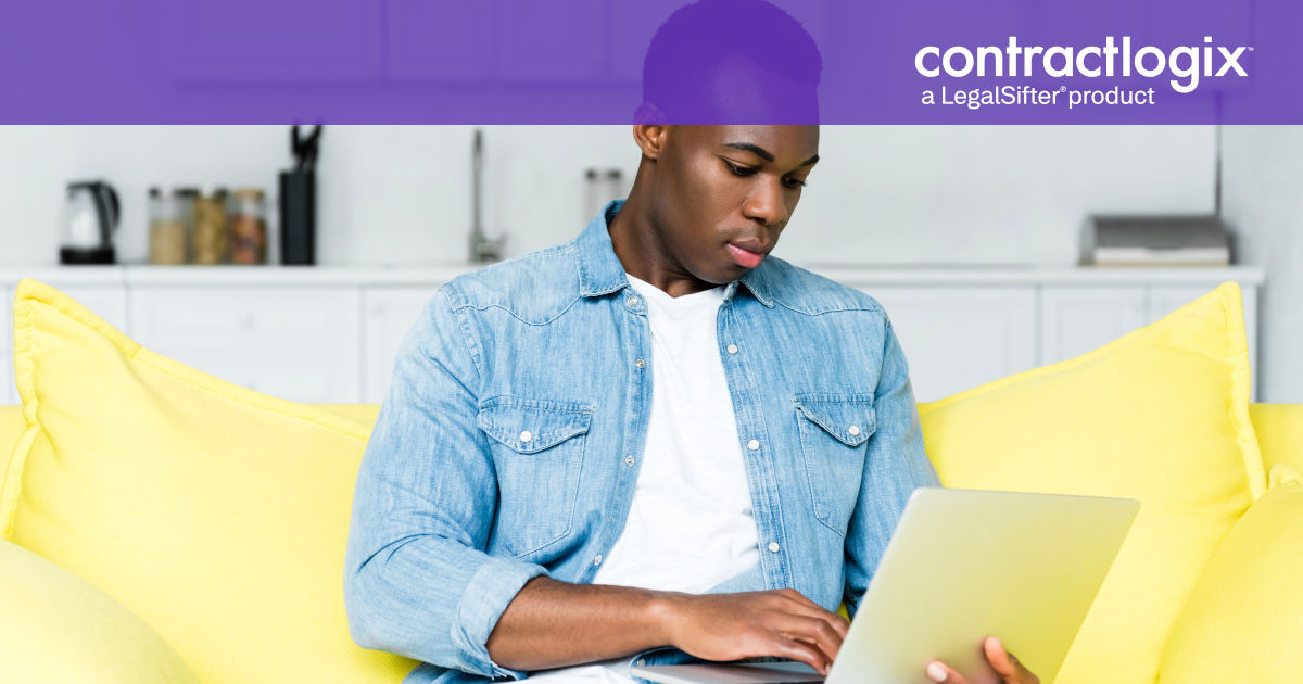 man sitting on couch using computer to learn what is contract management