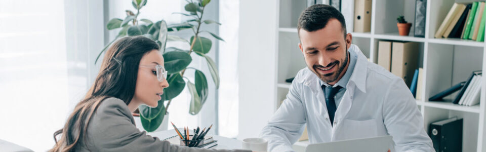 person pointing at laptop with benefits of Contract Lifecycle Management Software for Healthcare