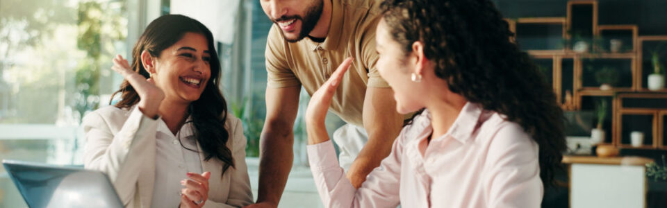 group of people two high fiving as they review how they can improve with contract operations​
