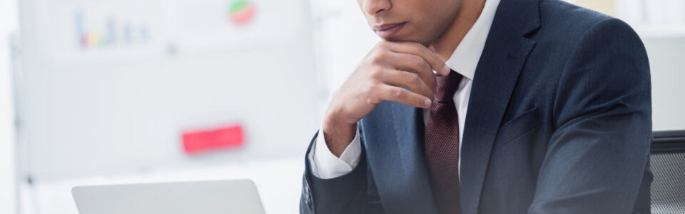 Business professional in a suit researching contract management consultants for digital contract solutions