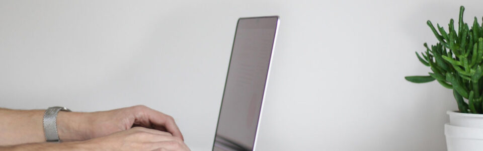 cropped shot of a professional working on laptop and learning about managed services for contract management