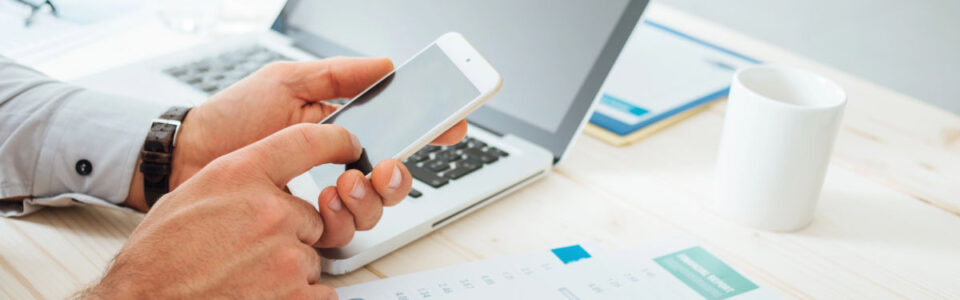 business man at desk using technology to calculate contract management OKRs